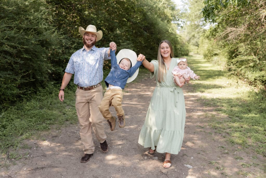Family cuddling and having fun during their full family photo session at Airfield Falls in Fort Worth, TX