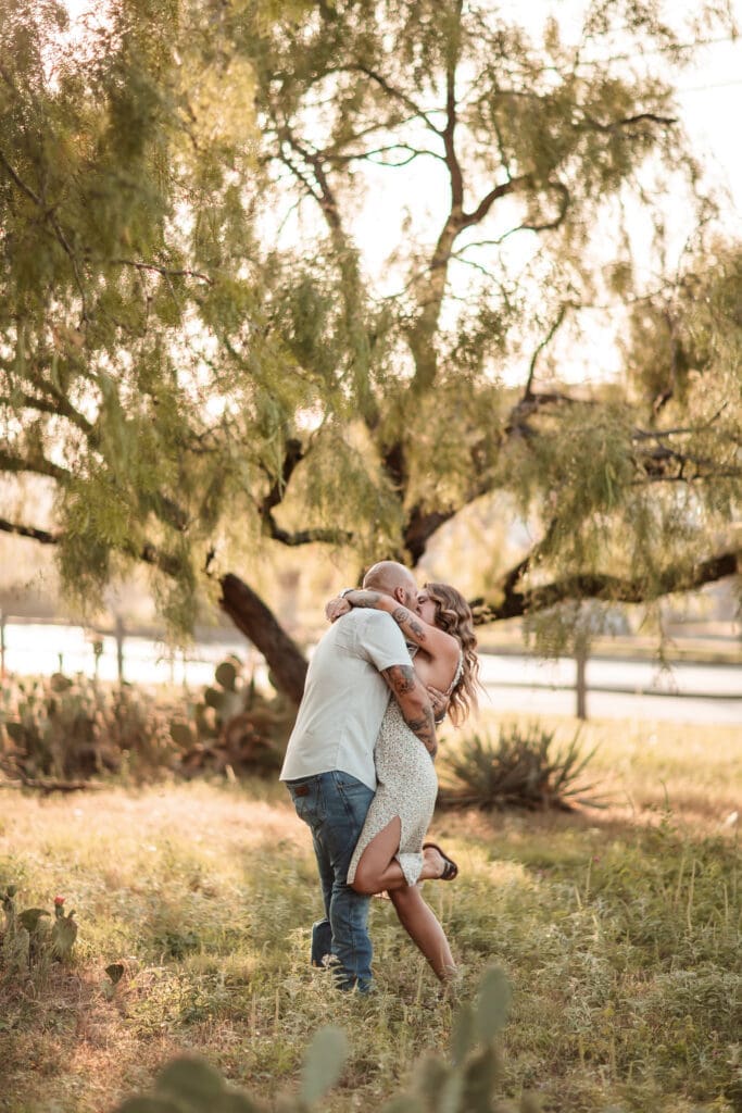 Husband and wife kissing at the Cactus Garden in Fort Worth during their golden hour family photography session