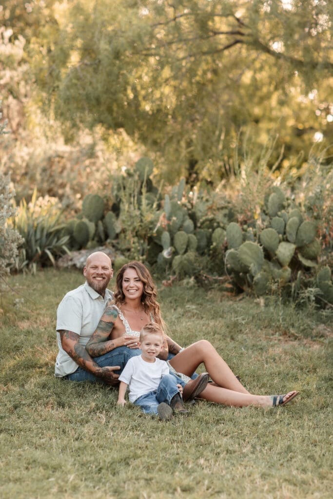 Husband and wife snuggling their toddler at the Cactus Garden in Fort Worth during their family photography session
