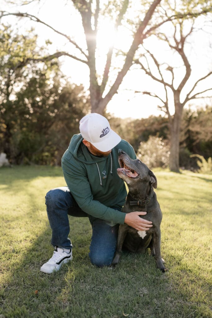 Man cuddling with dog during his mini photo session in Fort Worth, TX