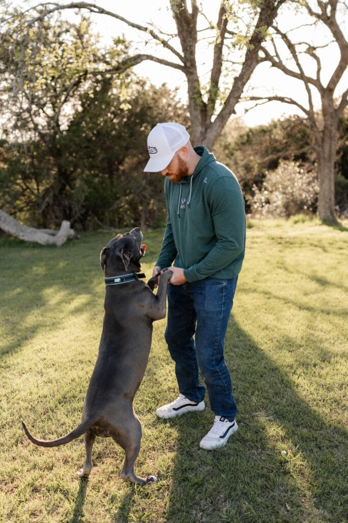 Man dancing with dog during his mini photo session in Fort Worth, TX