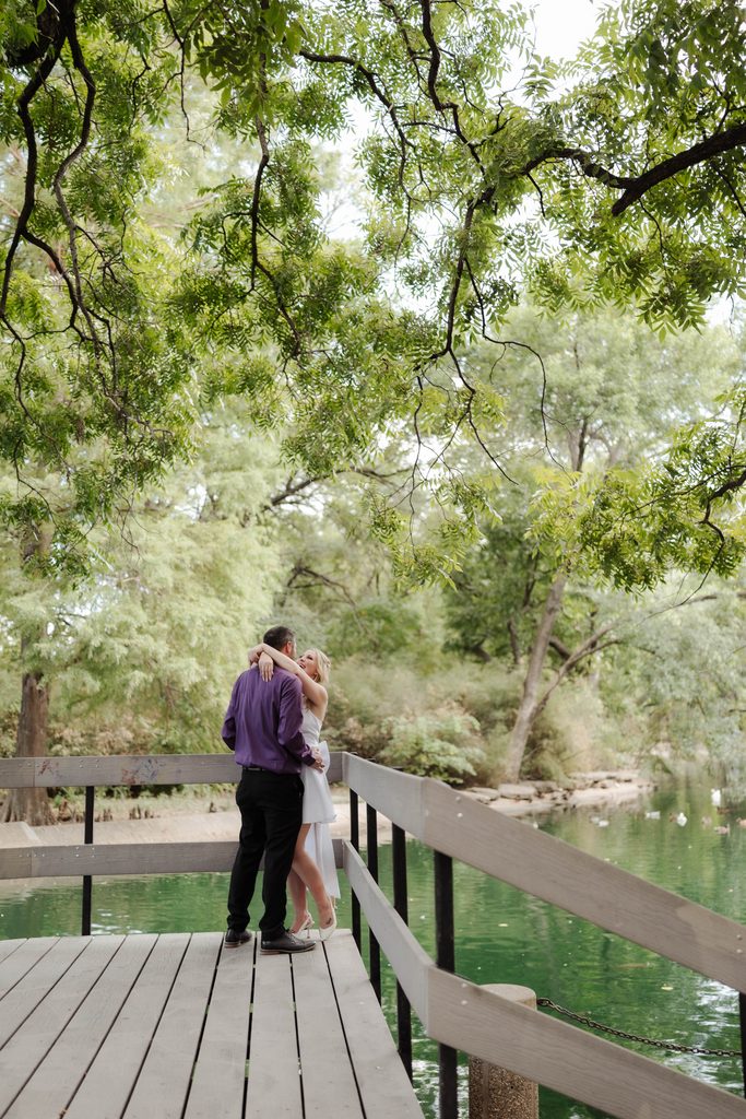 Bride and groom posing on the wood decking at the duck pond at Trinity Park in Fort Worth, TX