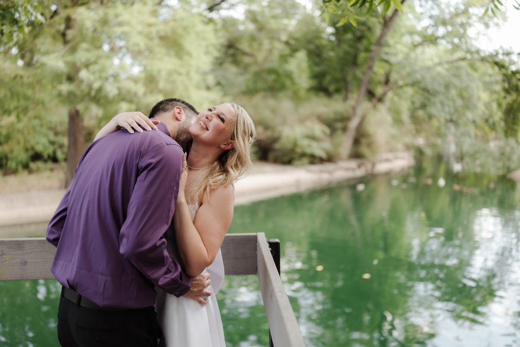 Bride and groom posing on the wood decking at the duck pond at Trinity Park in Fort Worth, TX