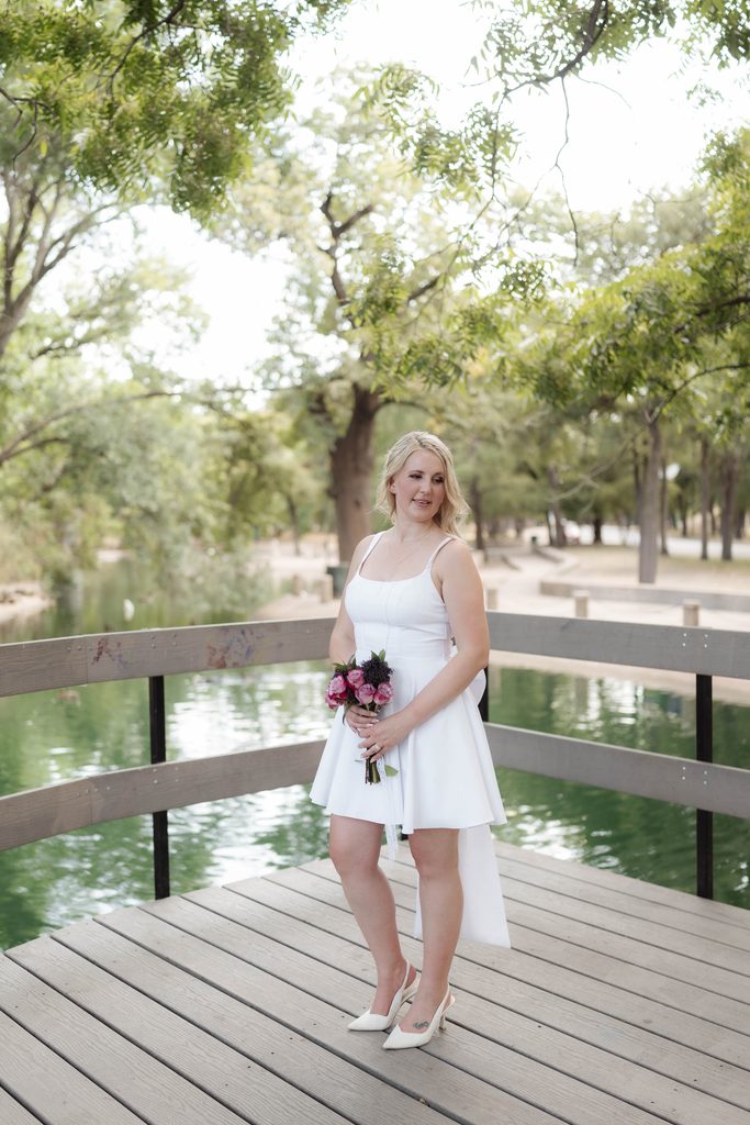 Bride posing on the wood decking at the duck pond at Trinity Park in Fort Worth, TX