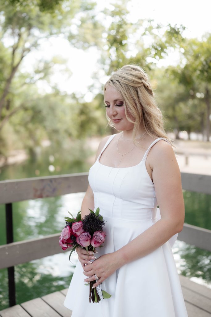 Bride posing on the wood decking at the duck pond at Trinity Park in Fort Worth, TX