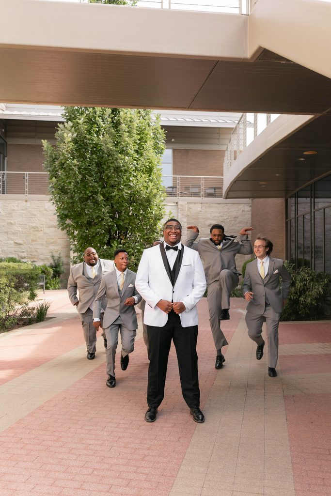Groom and his groomsmen being silly during their portraits