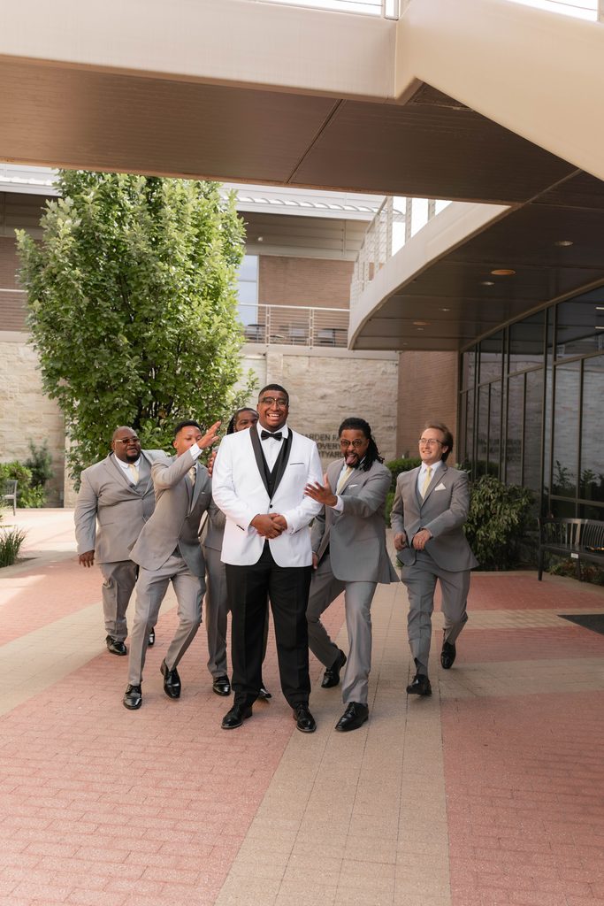 Groom and his groomsmen being silly during their portraits
