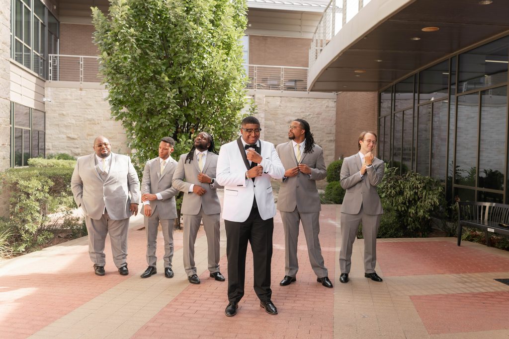 Groom and his groomsmen being silly during their portraits