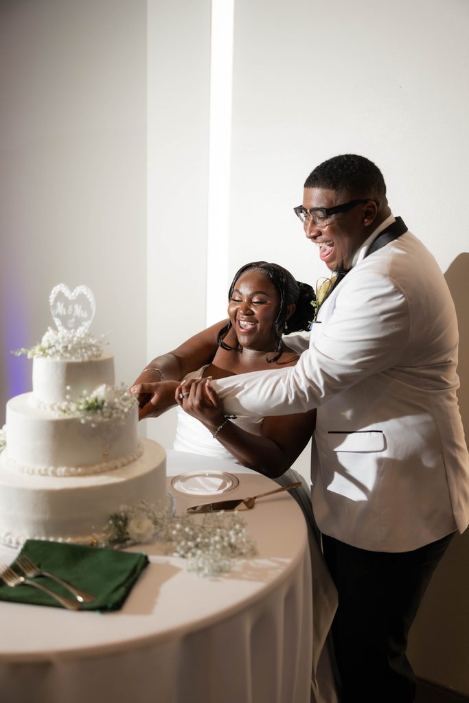 Bride and groom cutting their cake during their wedding at The Marty Leonard Chapel in Fort Worth, TX 