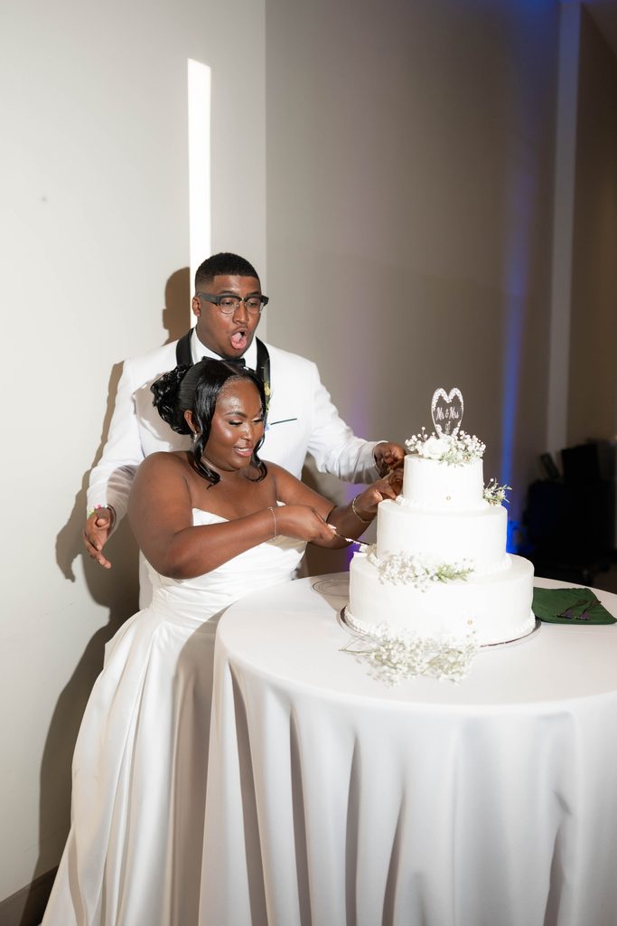 Bride and groom cutting their cake during their wedding at The Marty Leonard Chapel in Fort Worth, TX 