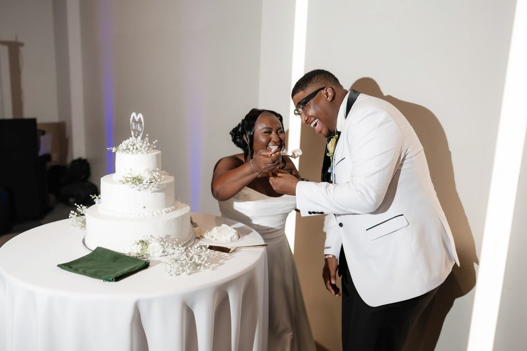 Bride and groom cutting their cake during their wedding at The Marty Leonard Chapel in Fort Worth, TX 
