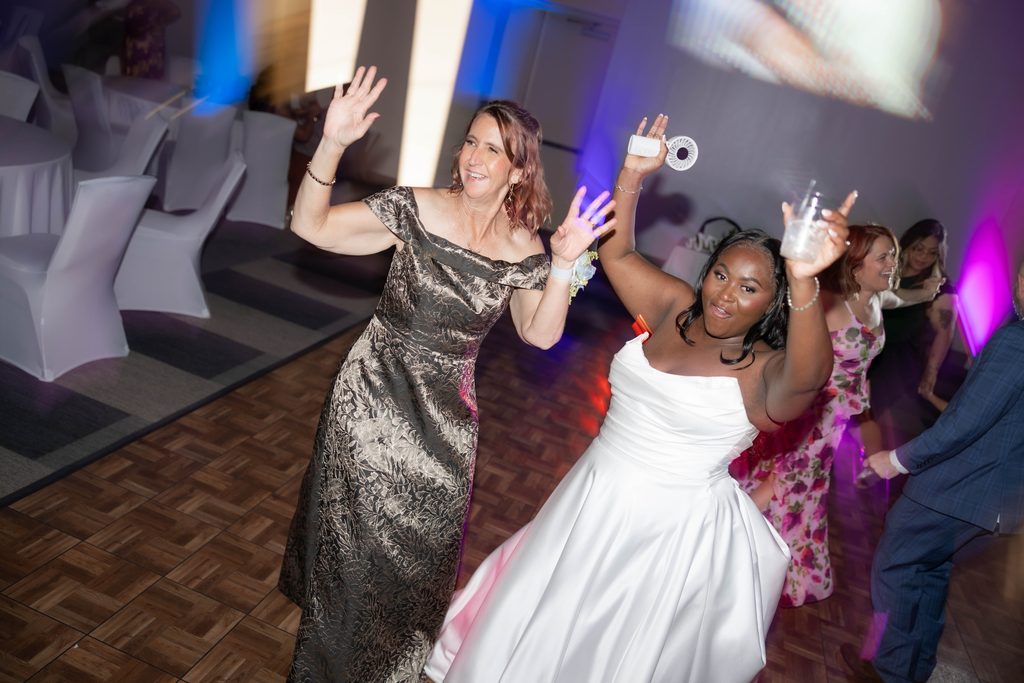 People having fun on the dancefloor during Alexandra's and James' wedding at the Amon Carter Center in Fort Worth, TX