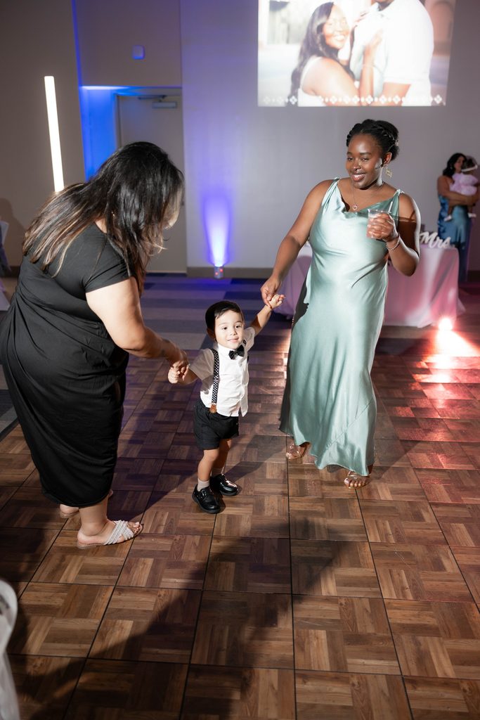 People having fun on the dancefloor during Alexandra's and James' wedding at the Amon Carter Center in Fort Worth, TX