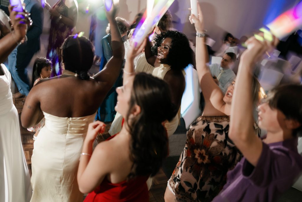 People having fun on the dancefloor during Alexandra's and James' wedding at the Amon Carter Center in Fort Worth, TX