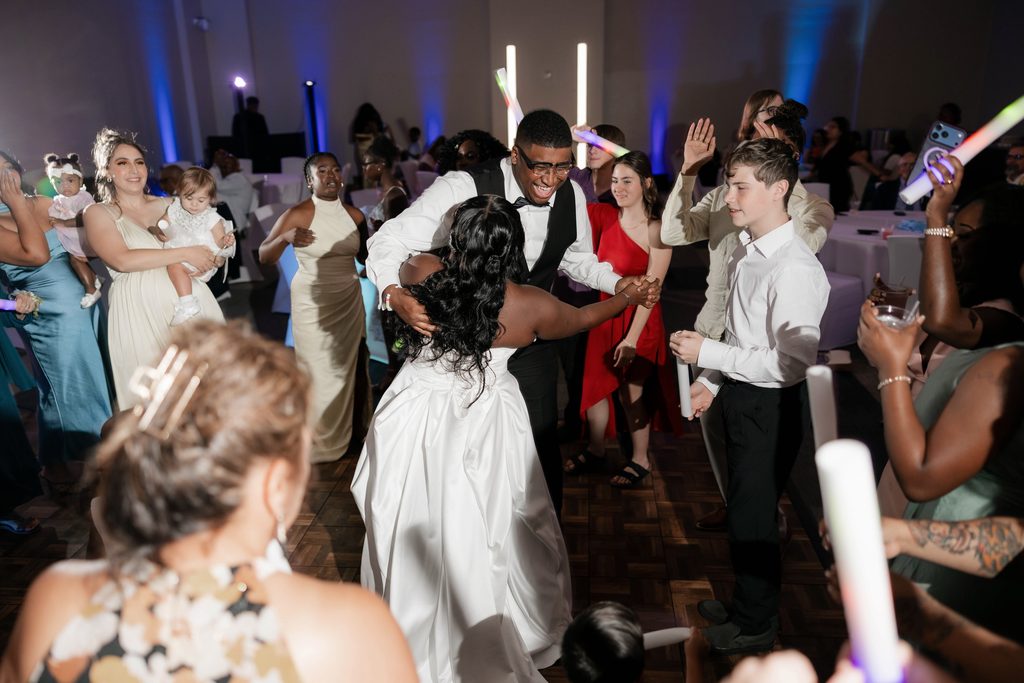 People having fun on the dancefloor during Alexandra's and James' wedding at the Amon Carter Center in Fort Worth, TX