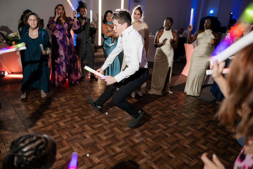 People having fun on the dancefloor during Alexandra's and James' wedding at the Amon Carter Center in Fort Worth, TX