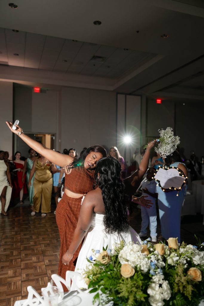 People having fun on the dancefloor during Alexandra's and James' wedding at the Amon Carter Center in Fort Worth, TX
