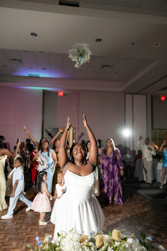 Bride tossing her bouquet at the Amon Carter Center in Fort Worth, TX