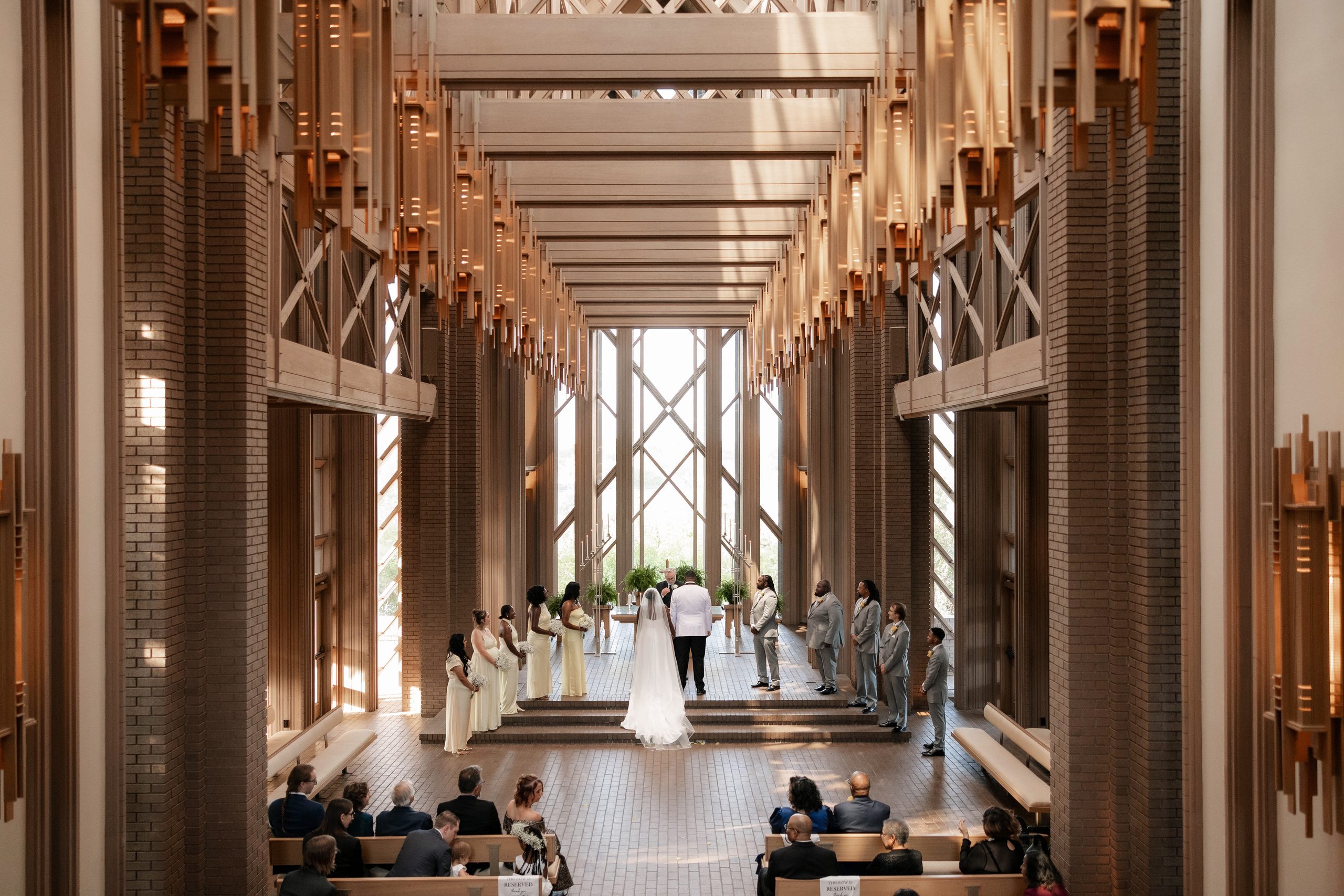 Bride and groom standing at the altar of The Marty Leonard Chapel in Fort Worth, TX