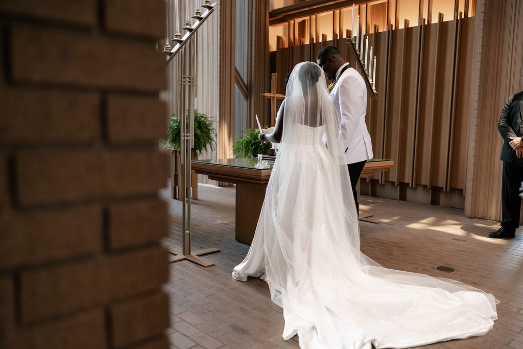 Bride and Groom lighting a candle during their wedding at Marty Leonard Chapel in Fort Worth, TX