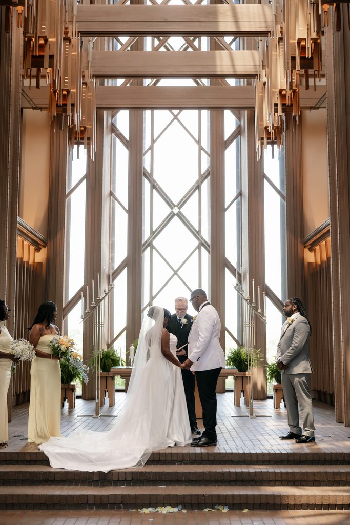 Bride and Groom standing at the altar during their wedding at Marty Leonard Chapel in Fort Worth, TX