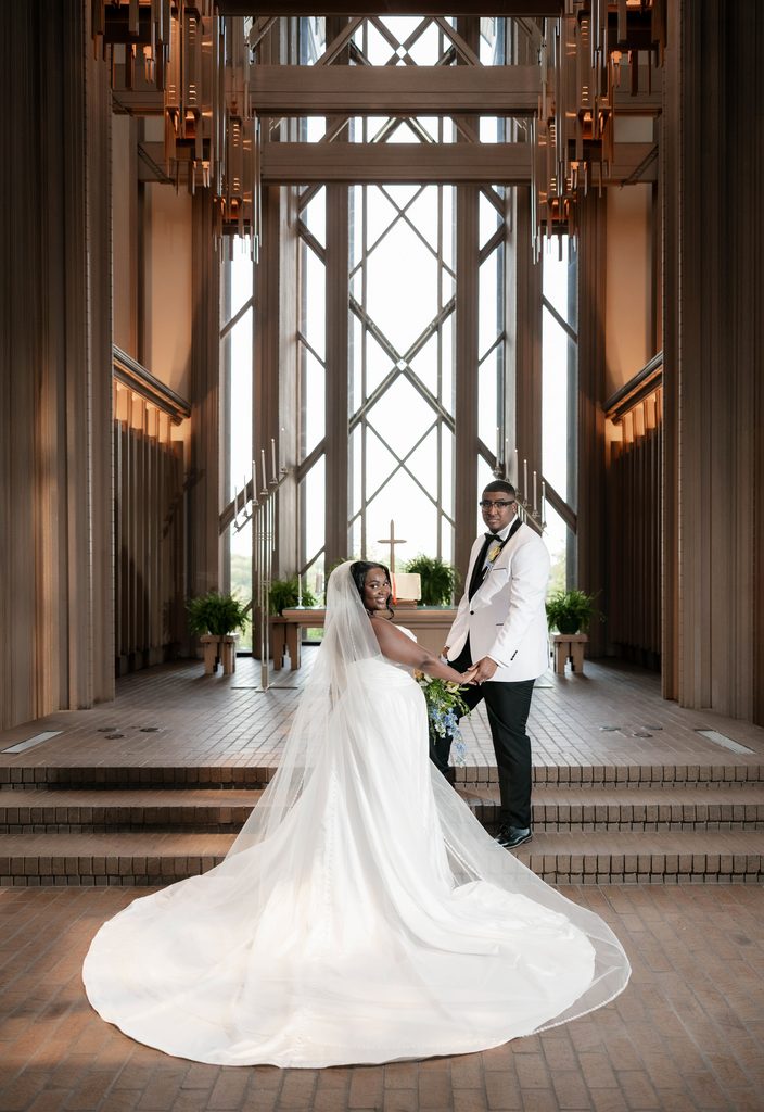 Bride and Groom standing at the altar during their wedding at Marty Leonard Chapel in Fort Worth, TX