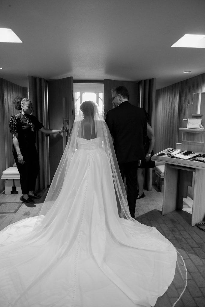 Bride holding onto her father before walking down the aisle
