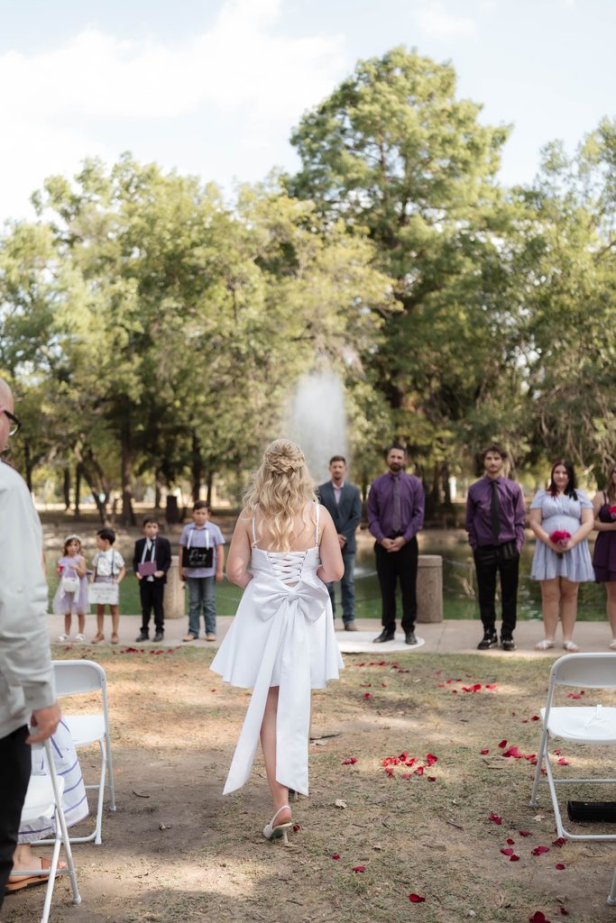 Bride and groom in front of the water fountain at the duckpond during their elopement at Trinity Park in Fort Worth, TX