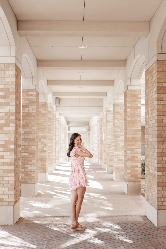 Girl posing during her senior portrait session at the TCU Campus in Fort Worth, TX
