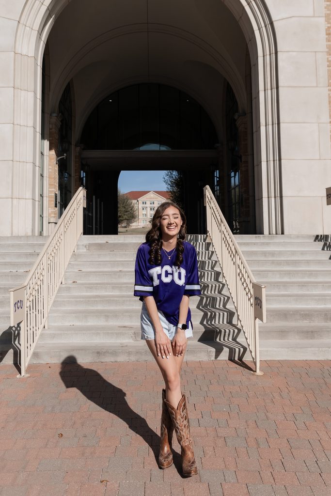 Girl posing during her senior portrait session at the TCU Campus in Fort Worth, TX