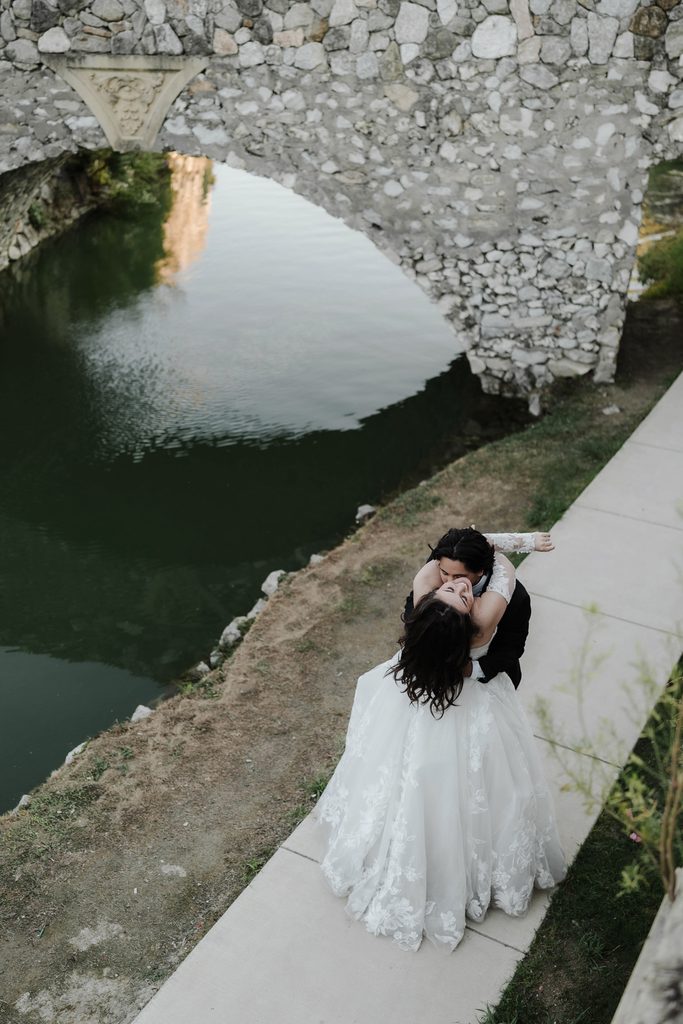 Bride and groom dancing along the water at Adriatica Village