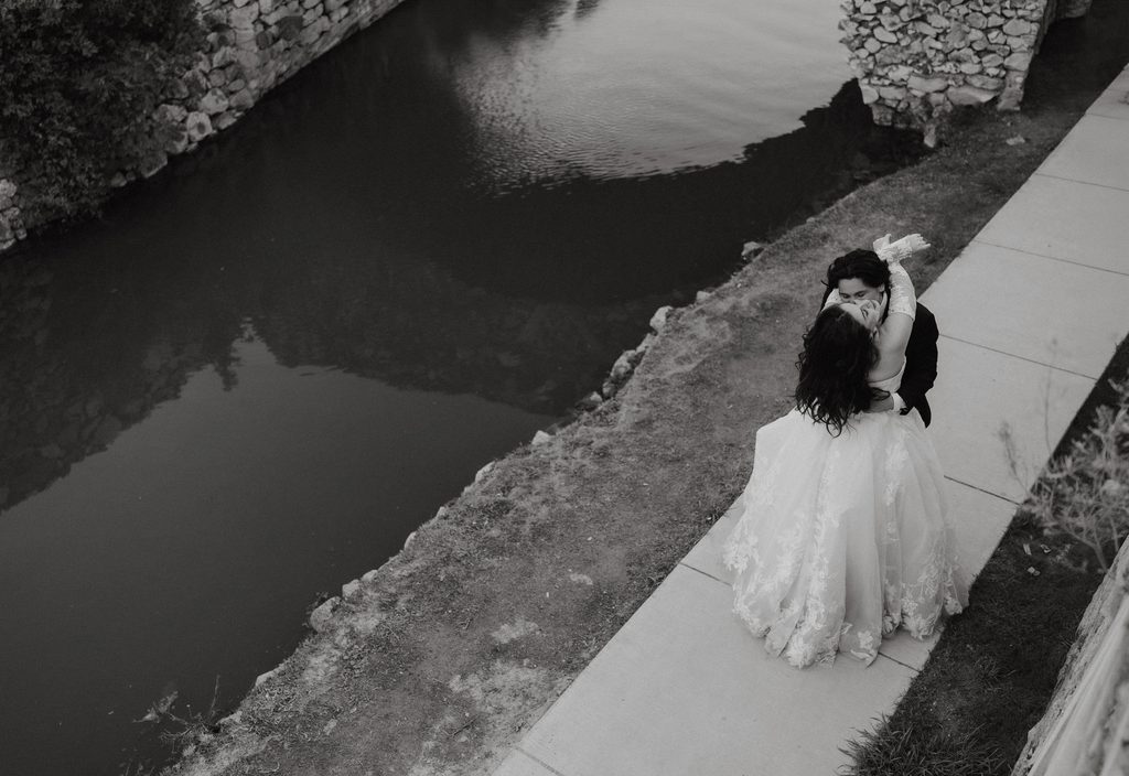 Bride and groom dancing along the water at Adriatica Village