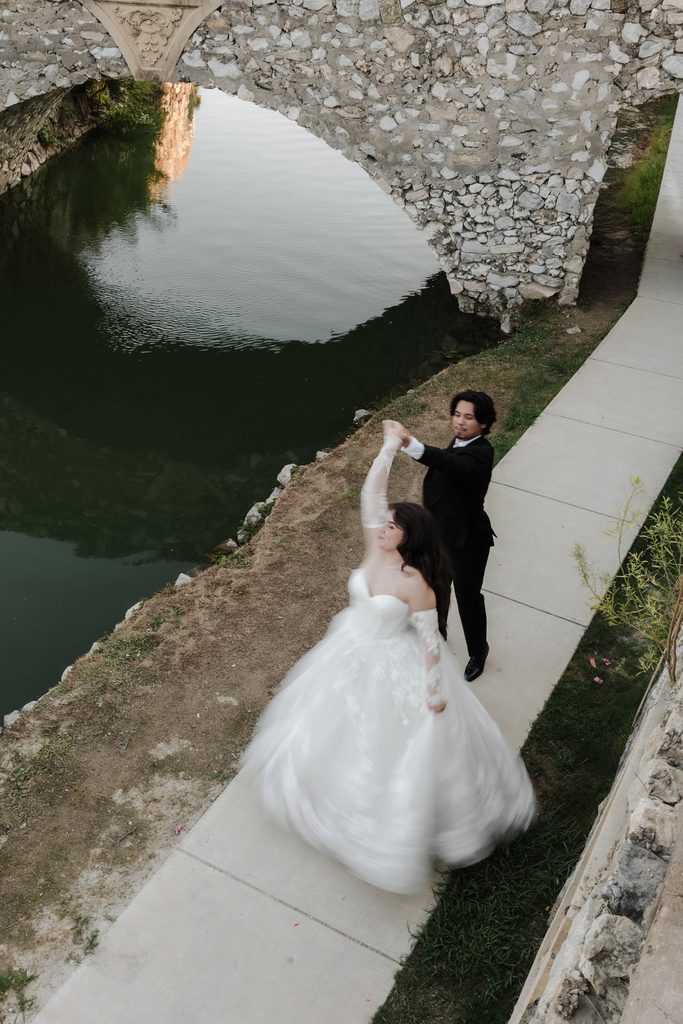 Bride and groom dancing along the water at Adriatica Village