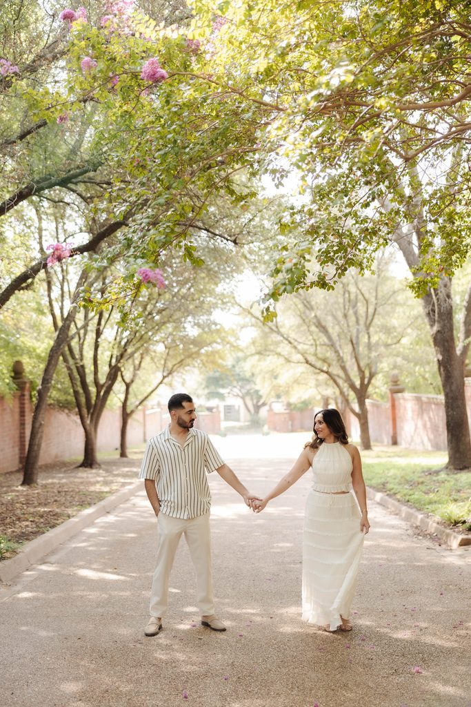 Man and woman holding hands at Chandor Gardens in Weatherford, TX