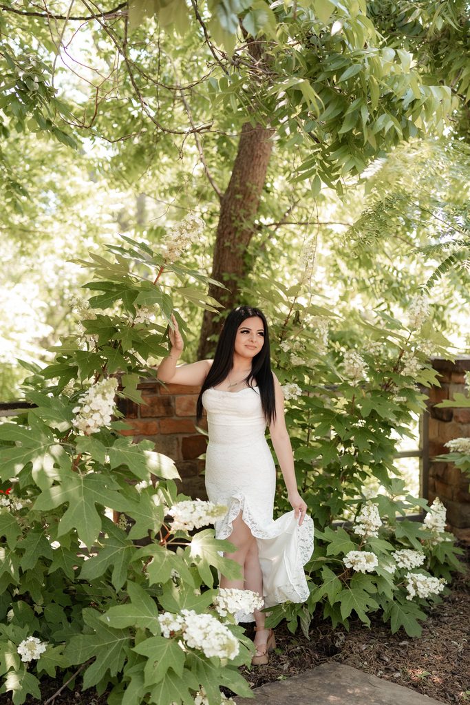 Portrait of girl at the Fort Worth Botanic Garden during her senior portrait session