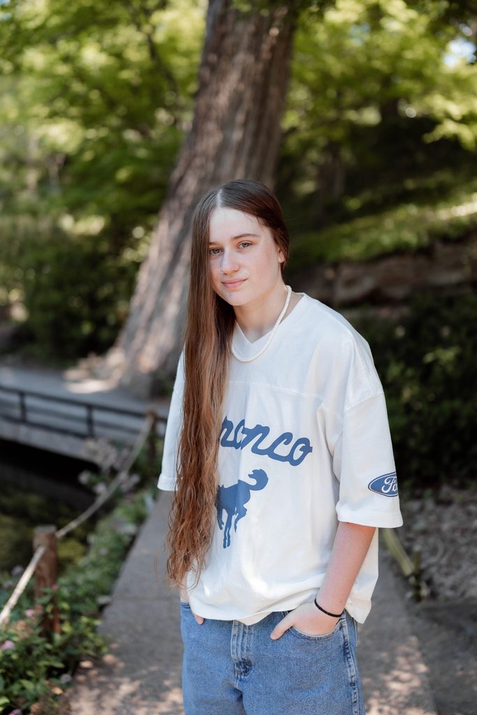 Portrait of girl at the Fort Worth Botanic Garden during her senior portrait session