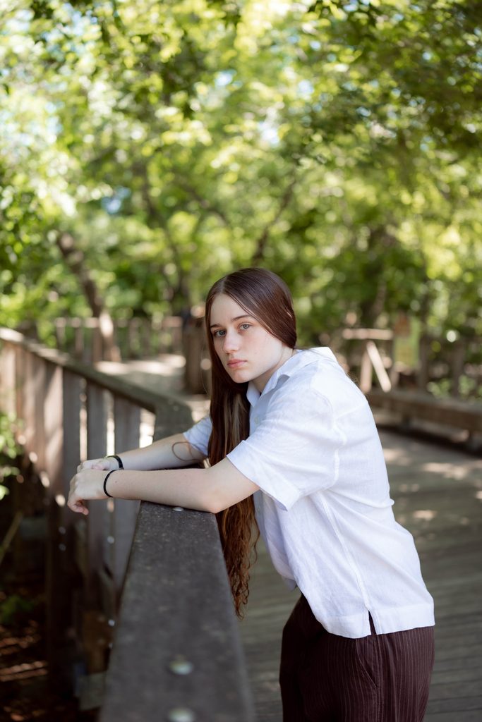 Portrait of girl at the Fort Worth Botanic Garden during her senior portrait session