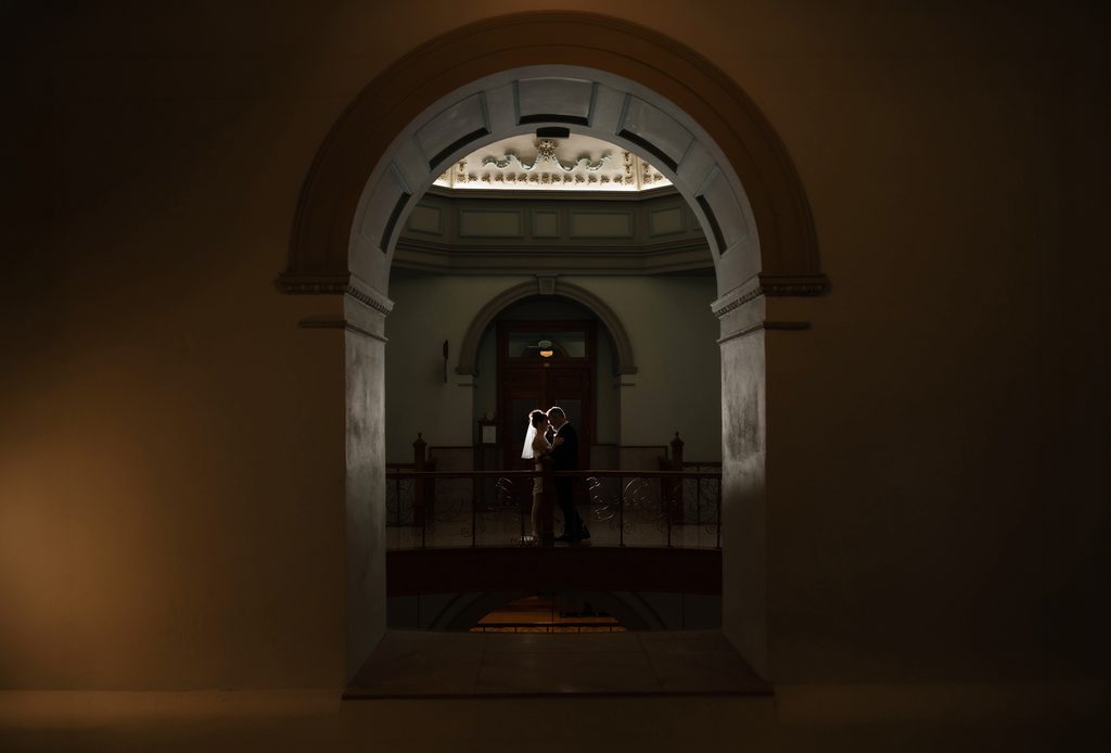 Bride + Groom posing for a moody portrait during their adventure elopement in Fort Worth