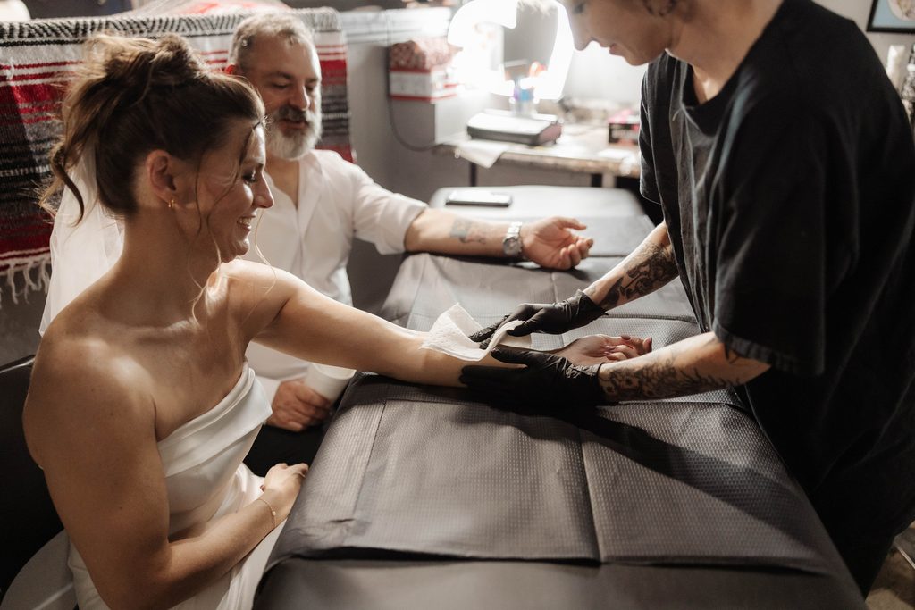 Bride and groom getting tattoos together at Knuckle Up Tattoo shop at the Fort Worth Stockyards