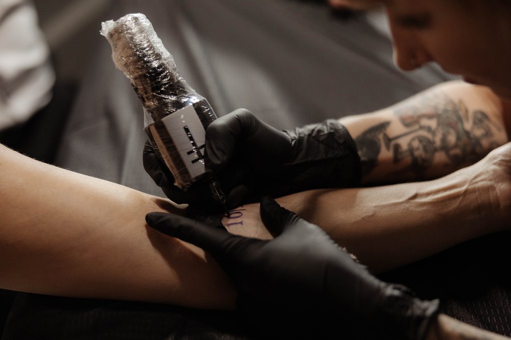 Bride and groom getting tattoos together at Knuckle Up Tattoo shop at the Fort Worth Stockyards