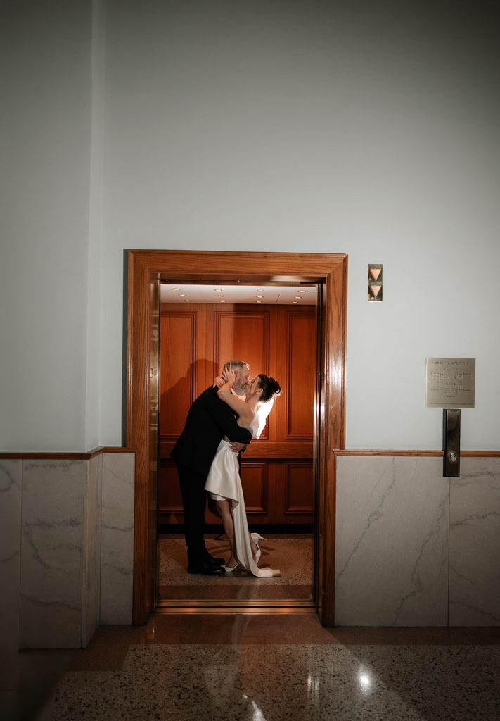 Bride + Groom kissing in the elevator at the Fort Worth Courthouse 