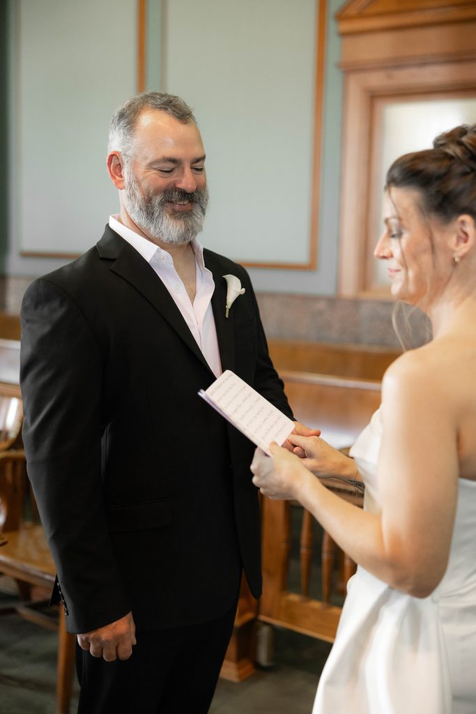 Bride + Groom exchanging vows at the Tarrant County Courthouse during their adventure elopement in Fort Worth