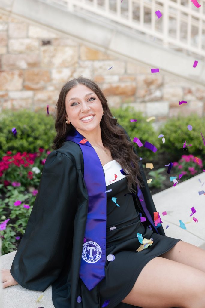 Dramatic lighting portrait of girl posing during her grad session at the TCU Campus in Fort Worth, TX